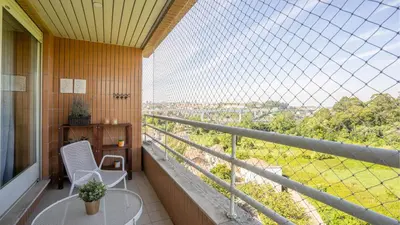 a balcony with a table and chairs and a view at Infante Cozy 1BR w Parking by LovelyStay in Vila Nova de Gaia