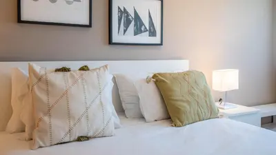 a bedroom with a white bed with pillows at Infante Cozy 1BR w Parking by LovelyStay in Vila Nova de Gaia
