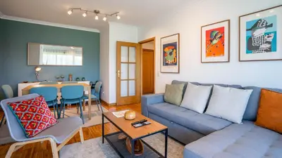a living room with a couch and a table at Infante Cozy 1BR w Parking by LovelyStay in Vila Nova de Gaia