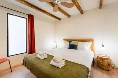 a bedroom with a large bed with towels on it at GuestReady - Modern Home In Gaia in Vila Nova de Gaia