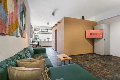 a living room with a couch and a table at GuestReady - Modern Home In Gaia in Vila Nova de Gaia