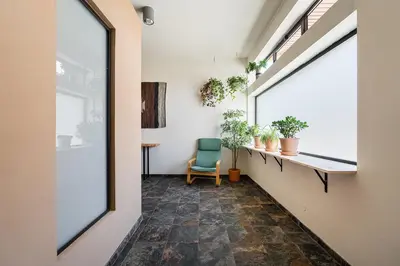 a hallway with a chair and a window at GuestReady - Modern Home In Gaia in Vila Nova de Gaia