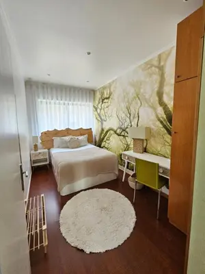 a bedroom with a bed and a painting on the wall at Porto Central Terrace Apartment in Porto