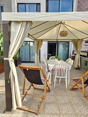 a table and chairs under an umbrella on a patio at Porto Central Terrace Apartment in Porto