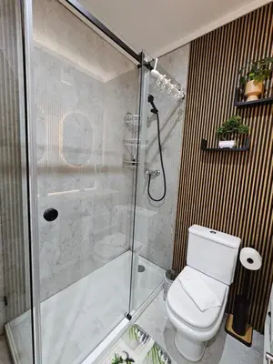 a bathroom with a glass shower with a toilet at Porto Central Terrace Apartment in Porto
