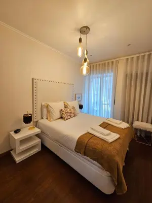 a bedroom with a large bed and a window at Porto Central Terrace Apartment in Porto