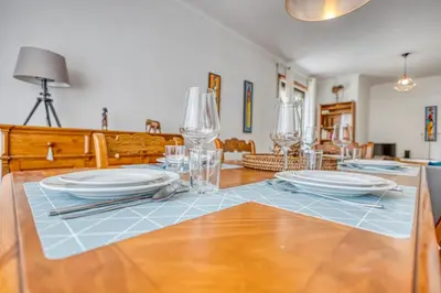 a dining room table with plates and glasses on it at OPORTO GUEST Lobo Flat with Parking in Porto