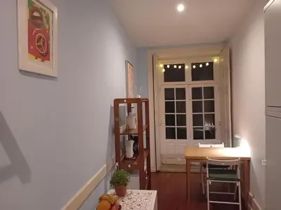 a room with a kitchen with a table and a window at Oupas 2 Lofts in Porto
