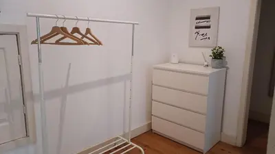a white room with a closet with a dresser at Oupas 2 Lofts in Porto