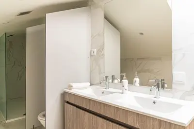 a bathroom with a sink and a mirror at The Porto Villa in Porto