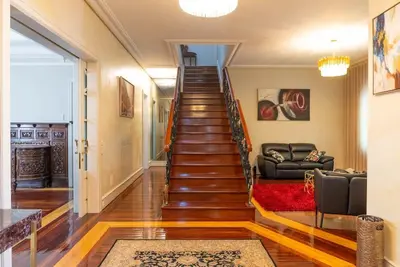 a staircase in a living room with a couch at The Porto Villa in Porto