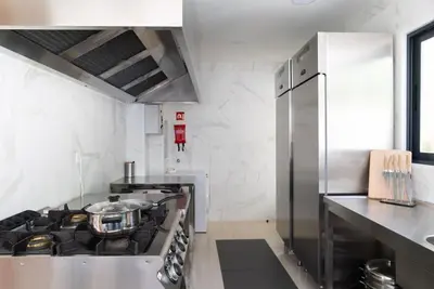 a kitchen with a stainless steel stove and refrigerator at The Porto Villa in Porto
