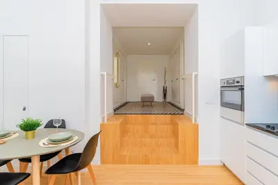 a kitchen and dining room with a table and a table and chairs at Charming Apartment • Porto in Porto