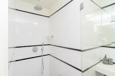 a white bathroom with a shower and a sink at Charming Apartment • Porto in Porto