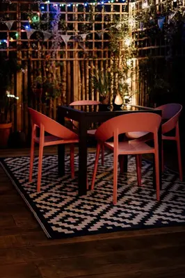 a table and two chairs on a rug in a room at Central apartment w/ garden terrace in Porto