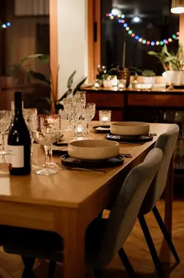 a wooden table with glasses and a bottle of wine at Central apartment w/ garden terrace in Porto