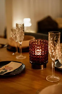 a table with wine glasses and a candle on it at Central apartment w/ garden terrace in Porto