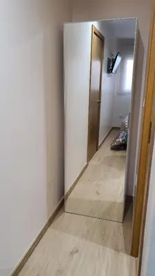 a mirror in a room with a hallway at Bedroom with private bathroom in the city center, next to the subway in Porto
