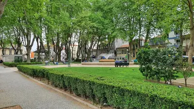 a park with a bench and trees and a fountain at Bedroom with private bathroom in the city center, next to the subway in Porto