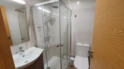 a bathroom with a shower and a toilet and a sink at Bedroom with private bathroom in the city center, next to the subway in Porto