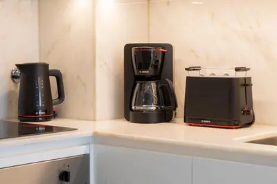 a kitchen with two coffee makers on a counter at T2 Constituição in Porto