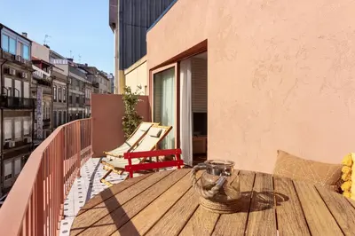 a wooden table on the balcony of a building at Trendy & Charming Apartment • Porto city center in Porto