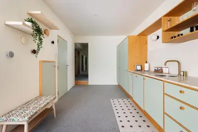 a kitchen with white cabinets and a bench at Trendy & Charming Apartment • Porto city center in Porto
