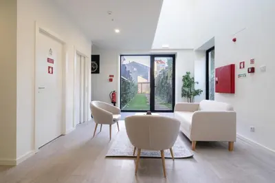 a living room with white furniture and a large window at Host Wise - Central Private Flats - Terrace in Porto