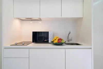 a bowl of fruit on a counter next to a microwave at Host Wise - Central Private Flats - Terrace in Porto