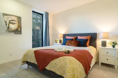 a bedroom with a bed and a large window at Host Wise - Central Private Flats - Terrace in Porto