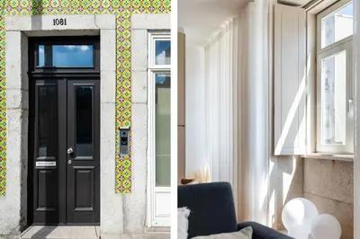 a house with a black door and a window at Stylish apartment in city center in Porto
