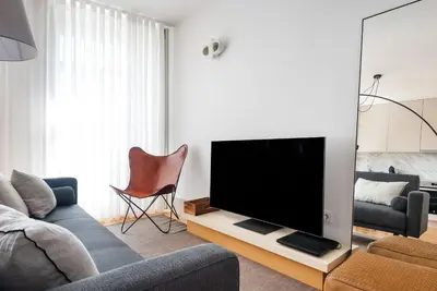 a living room with a couch and a flat screen tv at Stylish apartment in city center in Porto