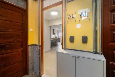 a hallway with a yellow wall and a door at WHome Prime Portal to Porto Your Gateway to Urban Wonders in Porto