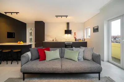 a living room with a couch with colorful pillows at WHome Prime Portal to Porto Your Gateway to Urban Wonders in Porto