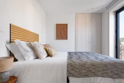 a bedroom with a large white bed with pillows at Lovely 2-bed in the city centre with a sunny balcony in Porto