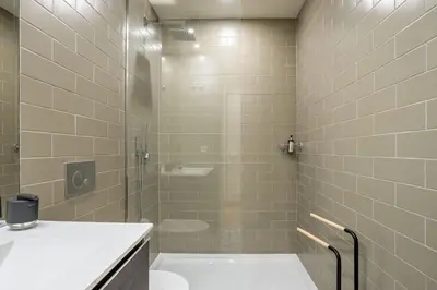 a bathroom with a shower and a toilet and a tub at Formosa Studio with Balcony by LovelyStay in Porto