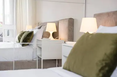 a living room with a couch and a mirror at Brittos Avenue Apartment in Gaia in Vila Nova de Gaia