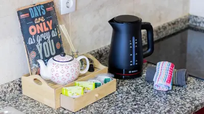 a counter top with a coffee maker and a box on it at Bright apartment next metro in Porto