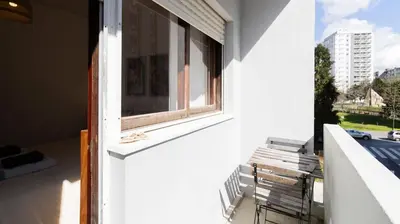 a window on the side of a white building at Bright apartment next metro in Porto