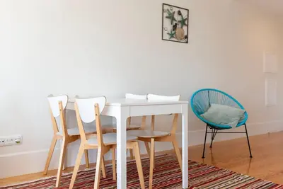 a white dining room table with four chairs at Cedofeita Studio - Your Porto Escape in Porto