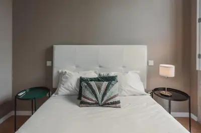 a bedroom with a bed with two towels on it at Mira Alfandega apartment in Porto