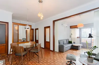 a living room with a table and a couch at Liiiving in Porto - Vintage Design Apartment in Porto