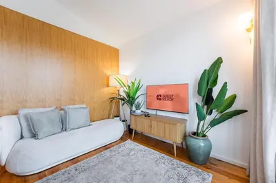a living room with a couch and a plant at GuestReady - An urban retreat with river view in Porto