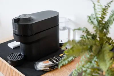 a coffee maker sitting on a table next to a plant at GuestReady - An urban retreat with river view in Porto