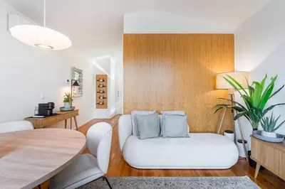 a living room with a white couch and a table at GuestReady - An urban retreat with river view in Porto