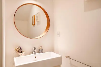 a bathroom with a white sink and a mirror at VIVA Boavista Vintage House in Porto