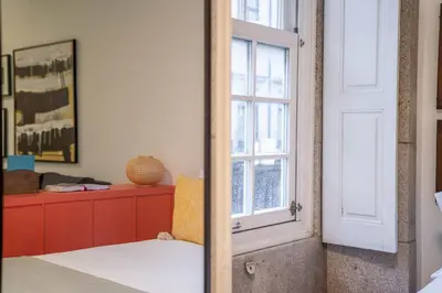 a bedroom with a door and a window at Green Hideaway by LovelyStay in Porto