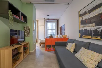 a living room with a couch and a television at Green Hideaway by LovelyStay in Porto