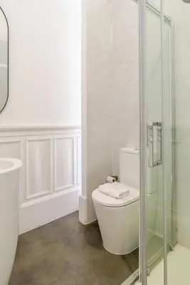 a bathroom with a toilet and a glass shower at Casa D'Almeida by Porto Stories in Porto