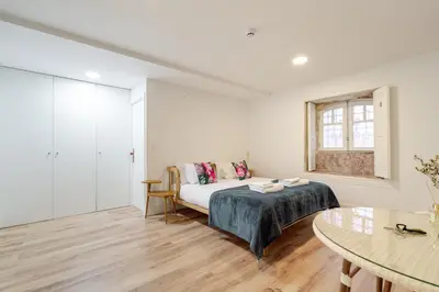 a white room with a bed and a window at Casa D'Almeida by Porto Stories in Porto